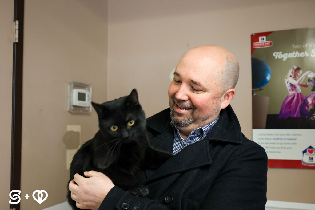 Michael, from Splash Media Group, playing with a black cat